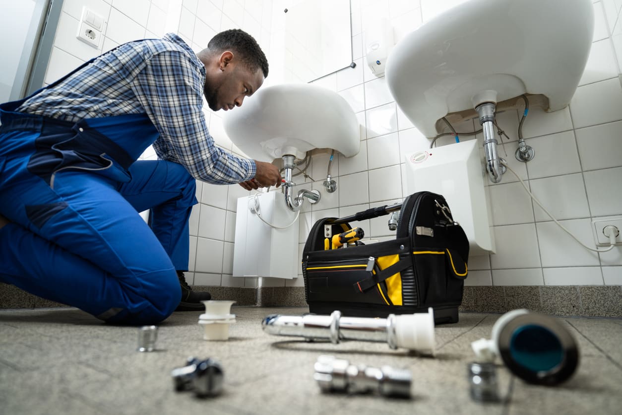 plumbing fixing a bathroom pipe