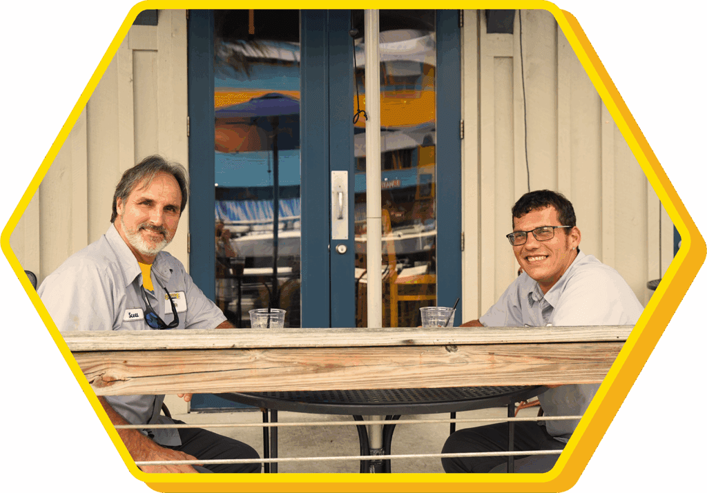 Two men sitting on a porch.